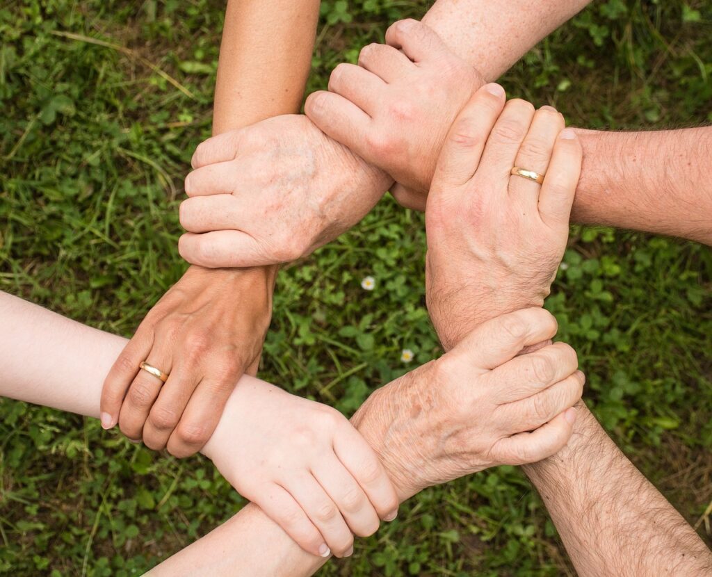 Internal Family Systems metaphor, hands gripping each other, supporting one another